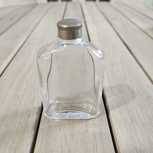 Vintage Flask liquor bottle, possibly for whiskey. flattened, rounded body.